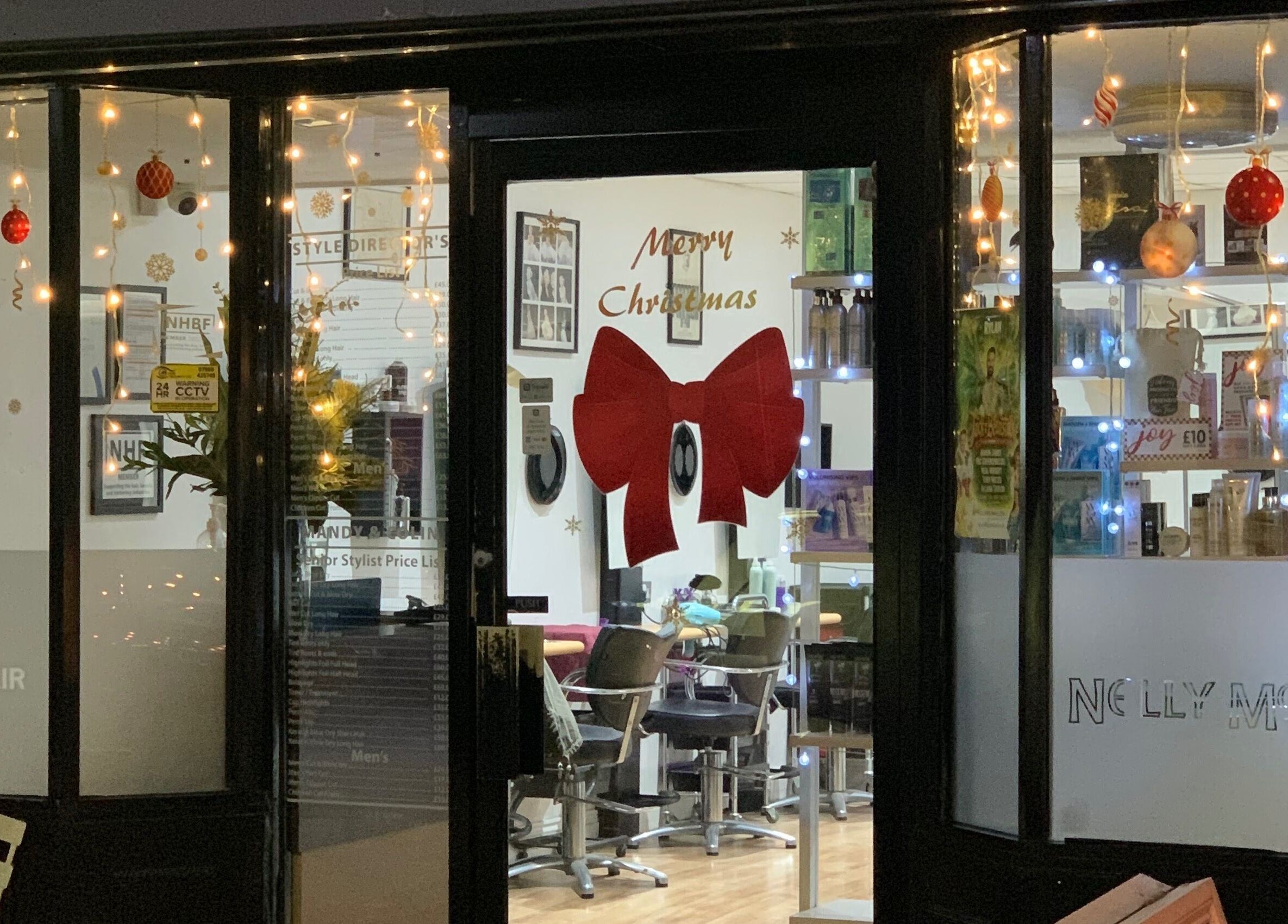 Nelly McNally salon in Southend-on-Sea, England, GB, adorned with festive Christmas decorations and warm lights.