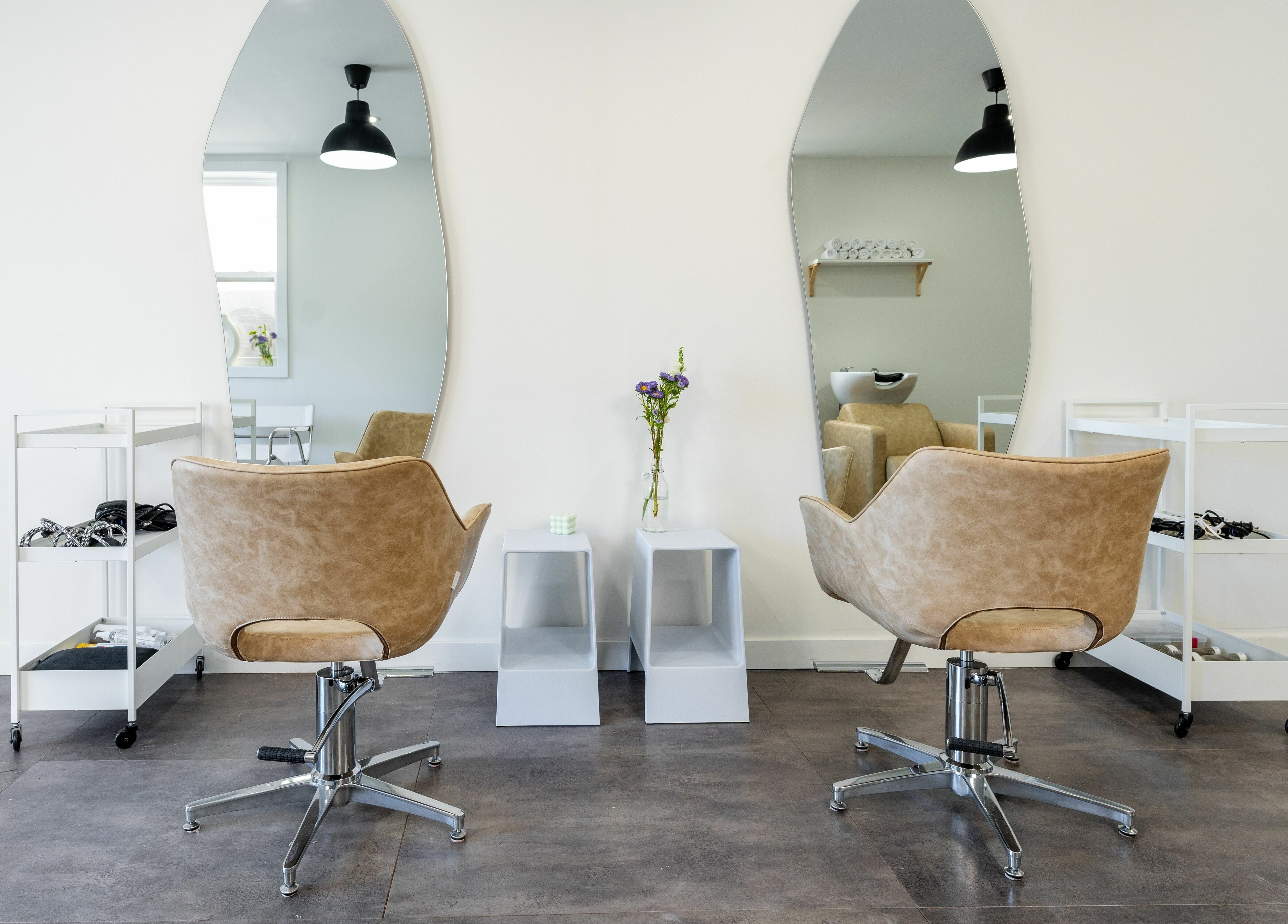 Elegant salon interior at Bare Bones The Space in Toronto, Ontario, CA, featuring stylish mirrors and chairs.