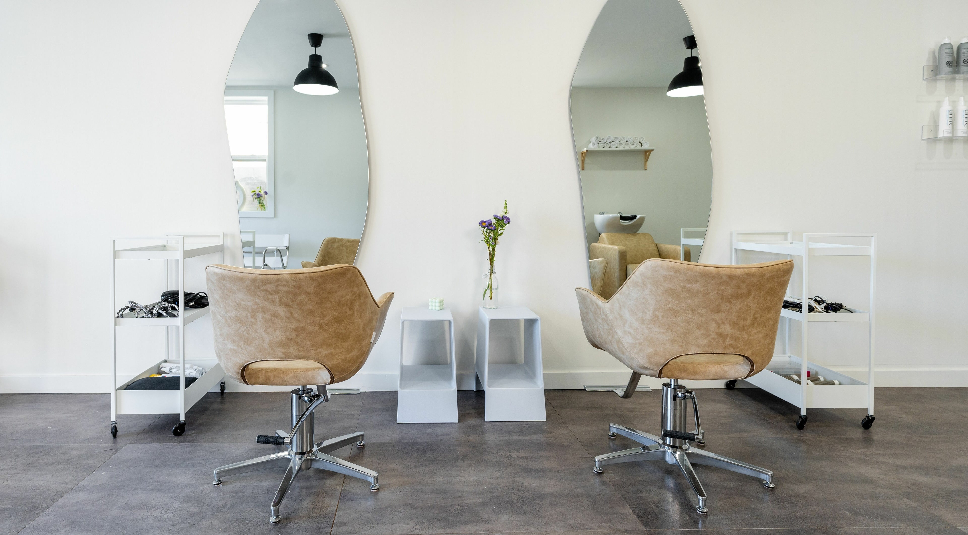 Elegant salon interior at Bare Bones The Space in Toronto, Ontario, CA, featuring stylish mirrors and chairs.
