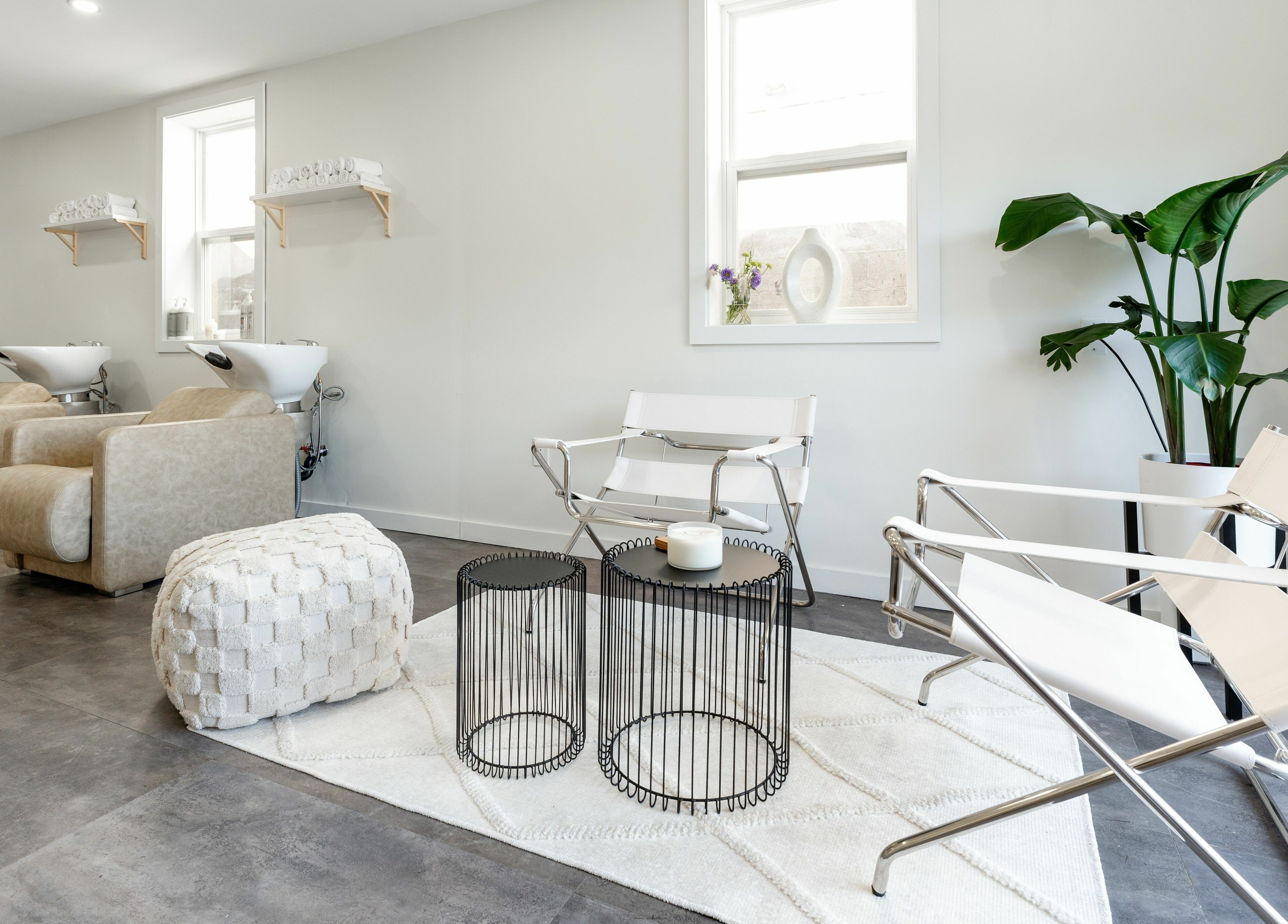 Chic seating area at Bare Bones The Space in Toronto, Ontario, CA with modern chairs and plants.