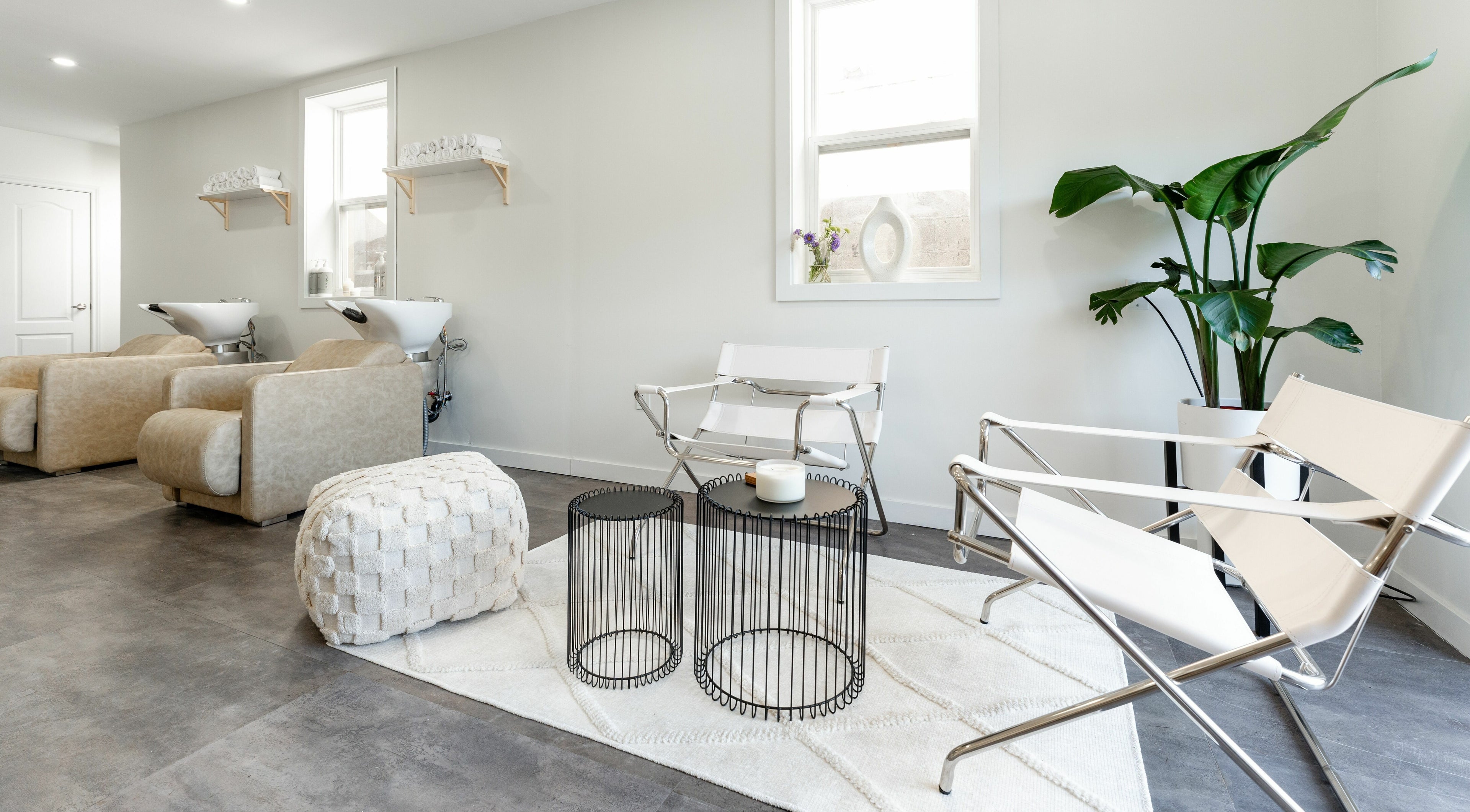 Chic seating area at Bare Bones The Space in Toronto, Ontario, CA with modern chairs and plants.