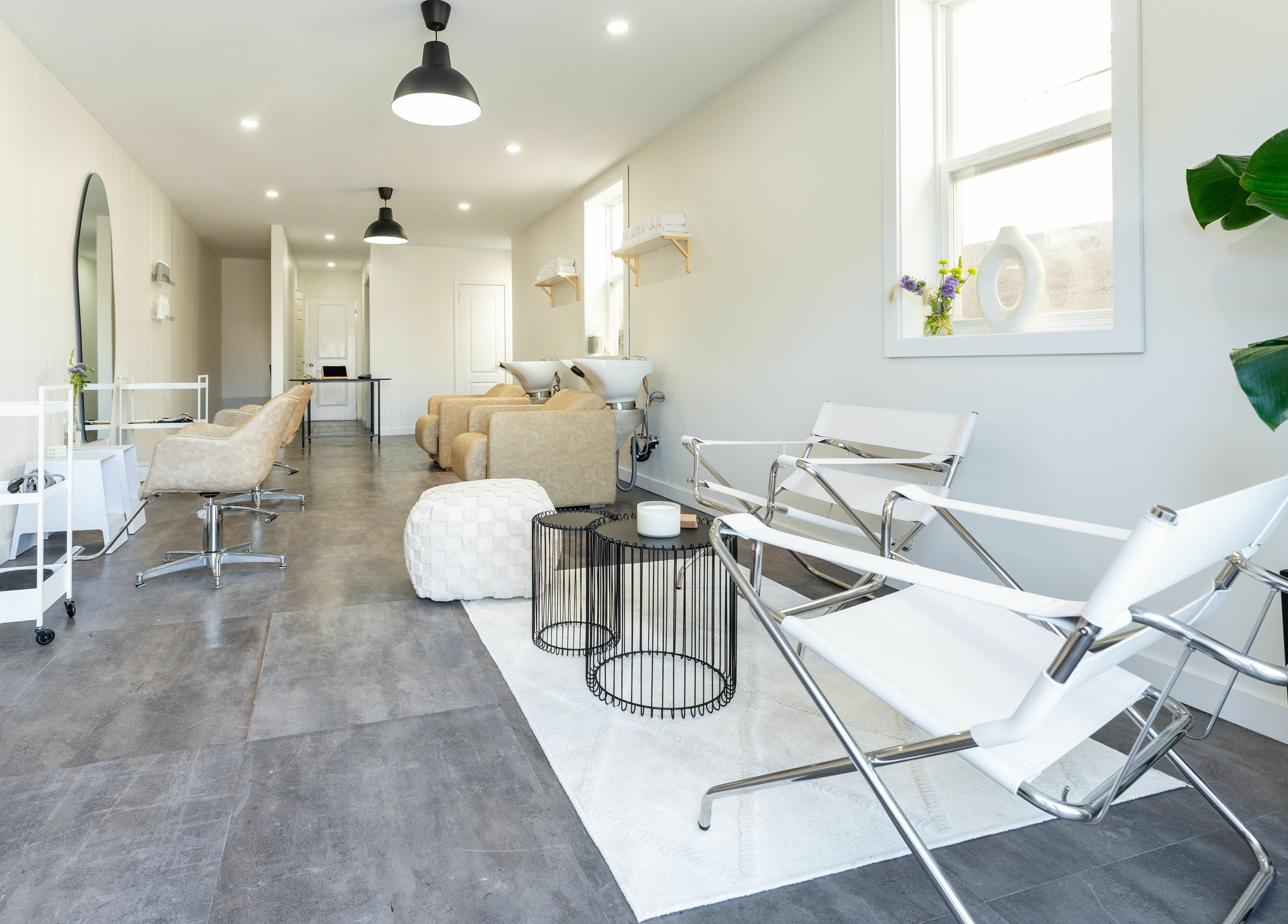 Modern salon interior at Bare Bones The Space, Toronto, Ontario, CA featuring sleek chairs and stylish decor.