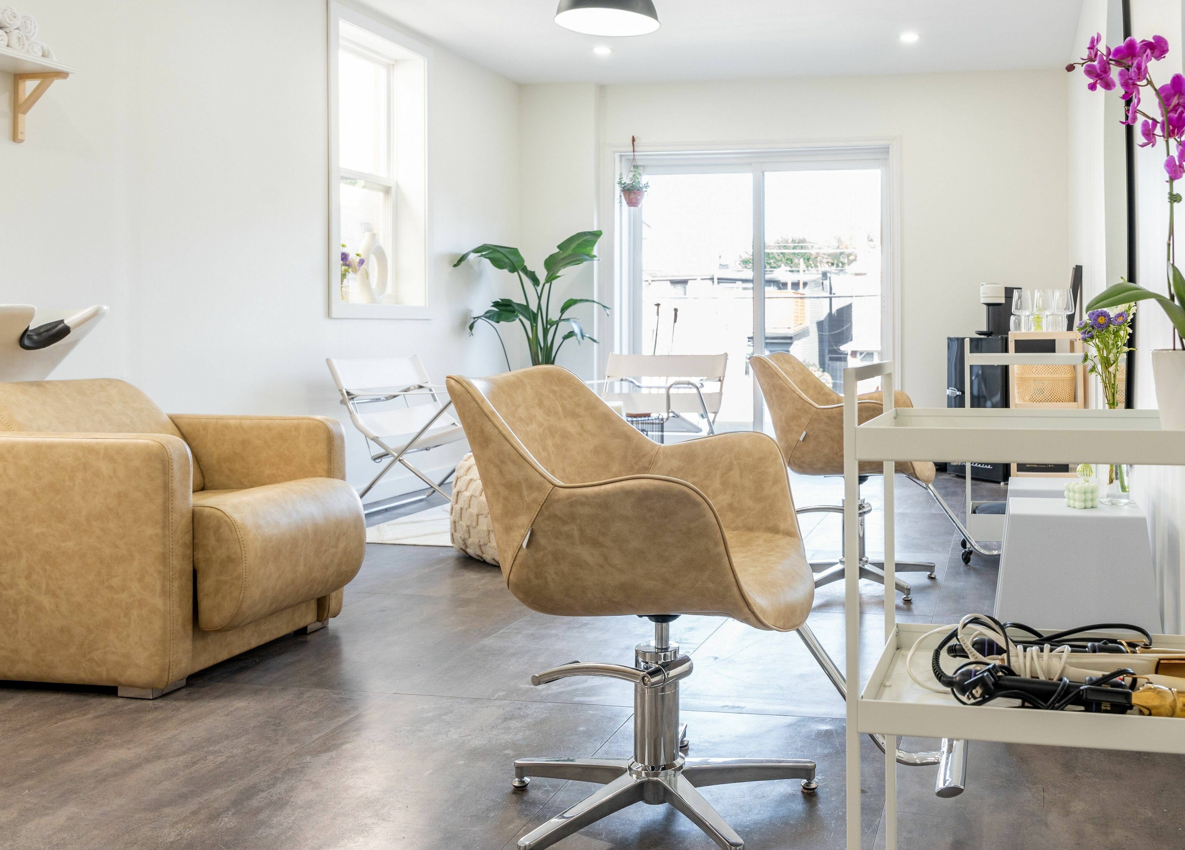Modern salon interior at Bare Bones The Space, Toronto, Ontario, CA with stylish chairs and bright ambiance.