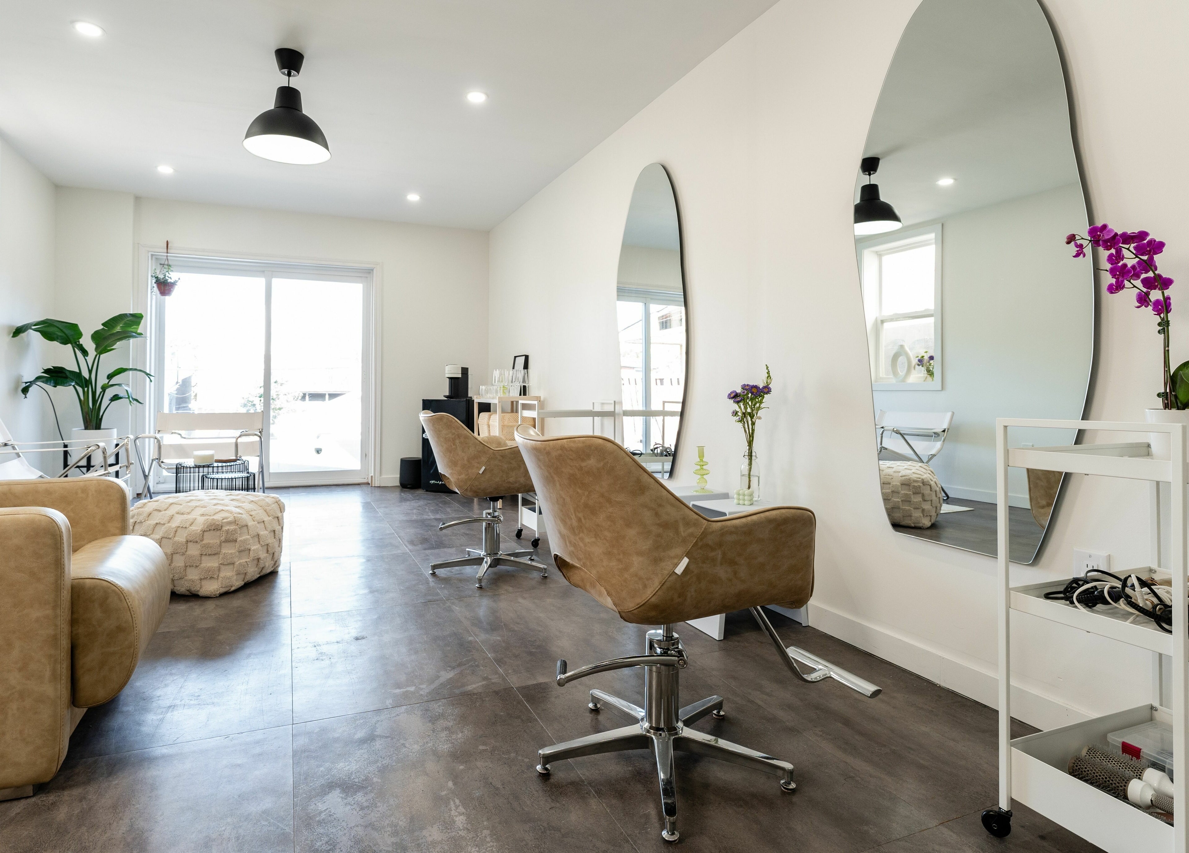 Elegant salon space at Bare Bones The Space in Toronto, Ontario, CA with modern chairs and mirrors.