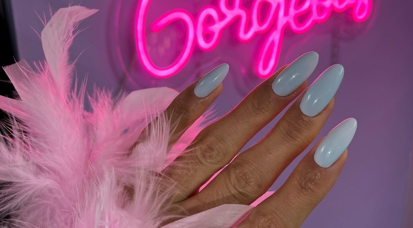 Elegant nail art at Russian Manicure. Awesome Nail Studio, New York, US, with pink neon sign.