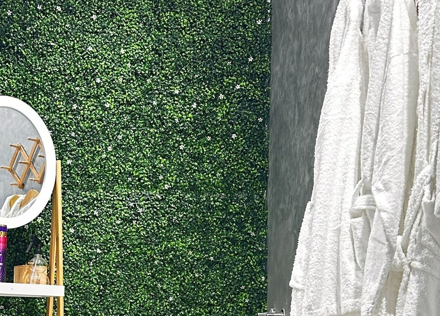 Relaxing spa nook at Styler Gents Salon and Spa - Rabdan Area in Abu Dhabi, AE featuring a lush green wall.