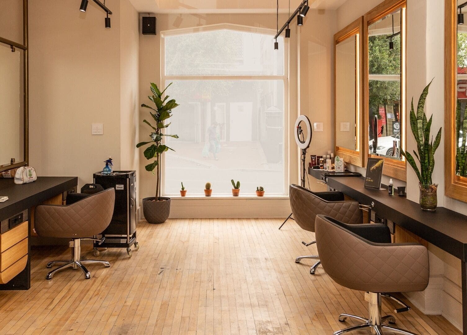 Modern interior of Excentric On Kloof salon, Cape Town, Western Cape, ZA with elegant chairs and mirrors.