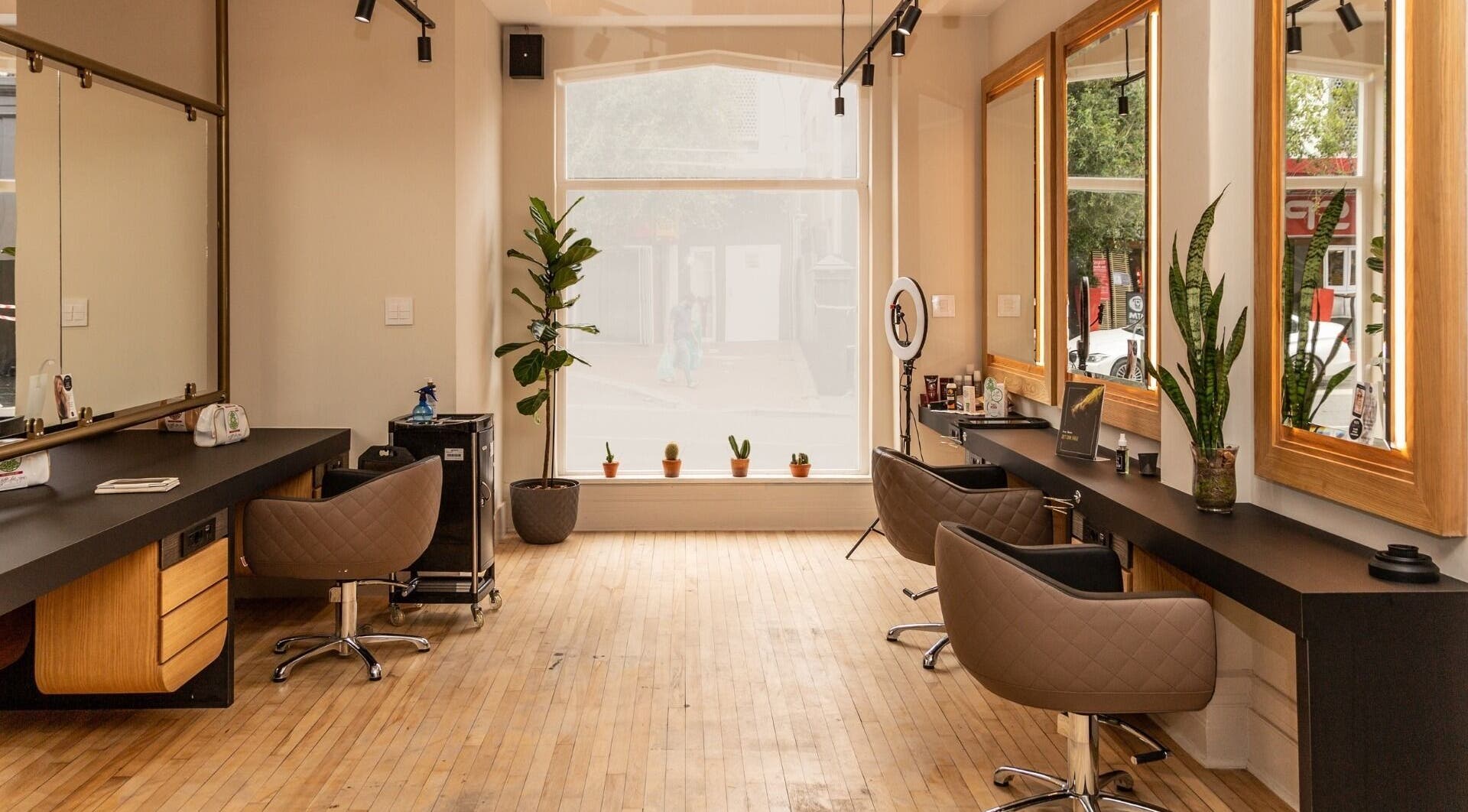 Modern interior of Excentric On Kloof salon, Cape Town, Western Cape, ZA with elegant chairs and mirrors.