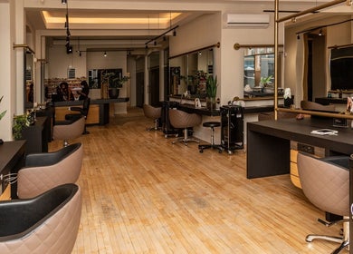 Modern salon interior at Excentric On Kloof, Cape Town, Western Cape, ZA showcasing sleek styling stations.