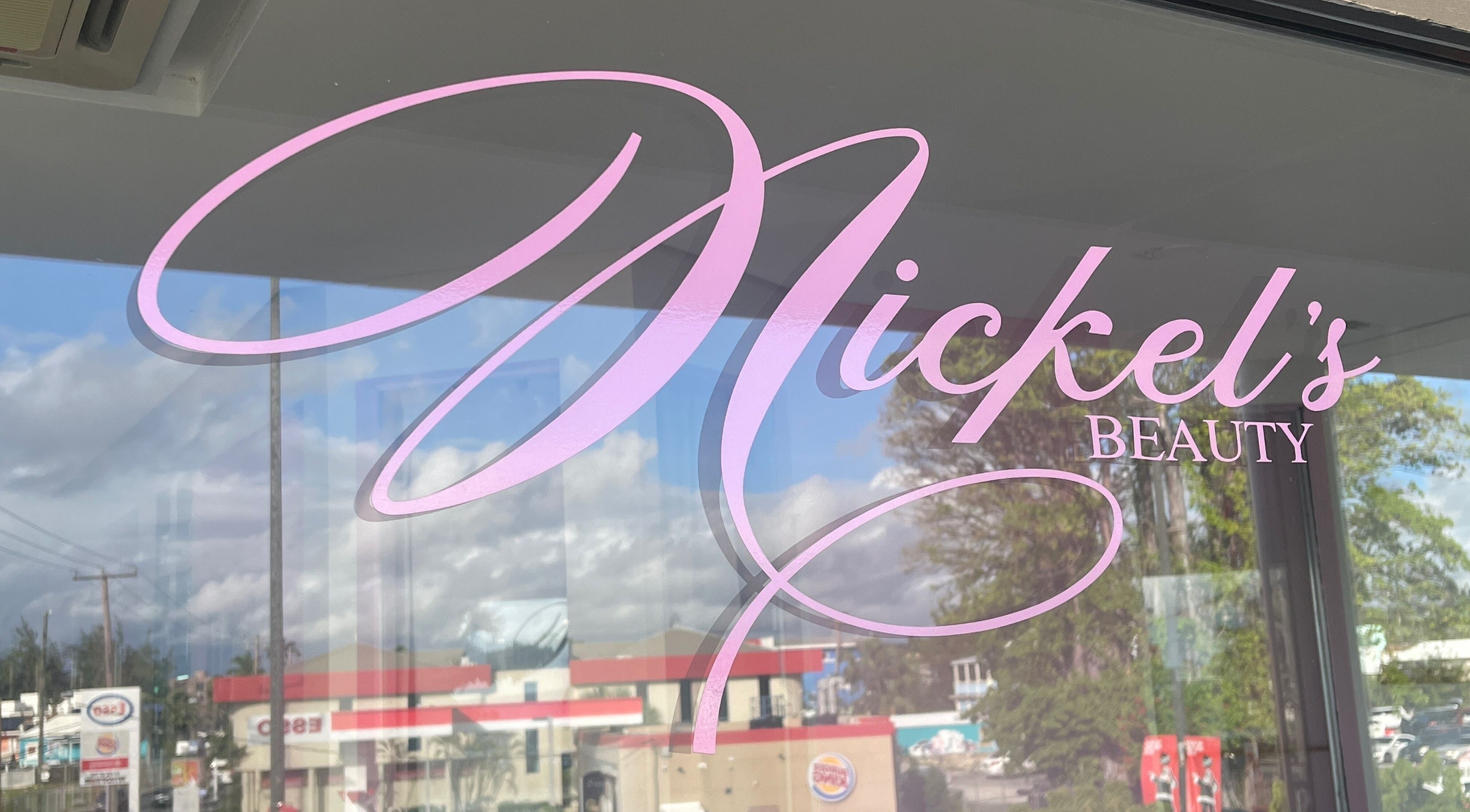 View of Nickel’s Beauty Clinic & Wellness Care logo on a glass window in Bridgetown, Christ Church, BB.