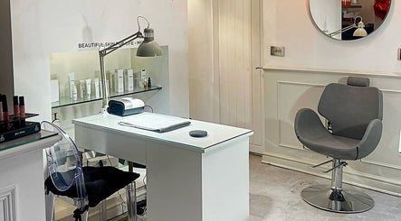 Modern beauty station at Beauty Boutique, Denby Dale, England, GB, featuring elegant chair and skincare products.