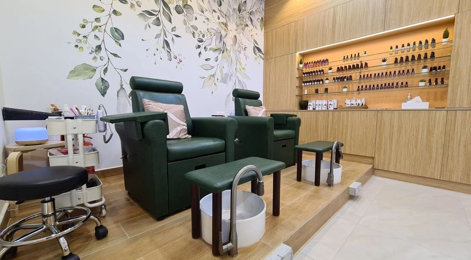 Relaxing pedicure chairs at Ikeda Beauty Salon L.L.C, Dubai, Dubai, AE, with lush green accents and elegance.