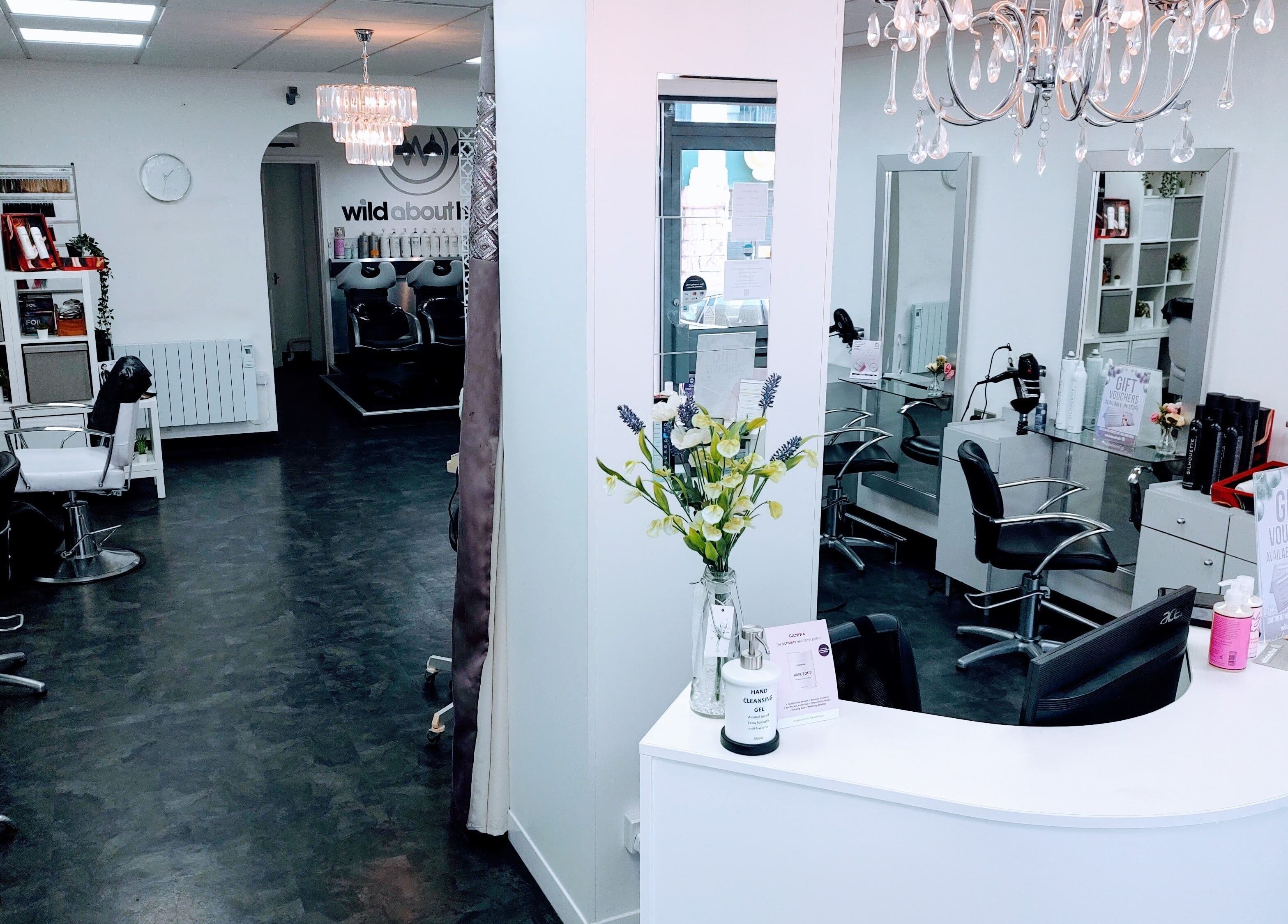 Chic interior of Wild About Hair, Torquay, England, GB. Stylish black chairs and modern decor create a welcoming ambiance.