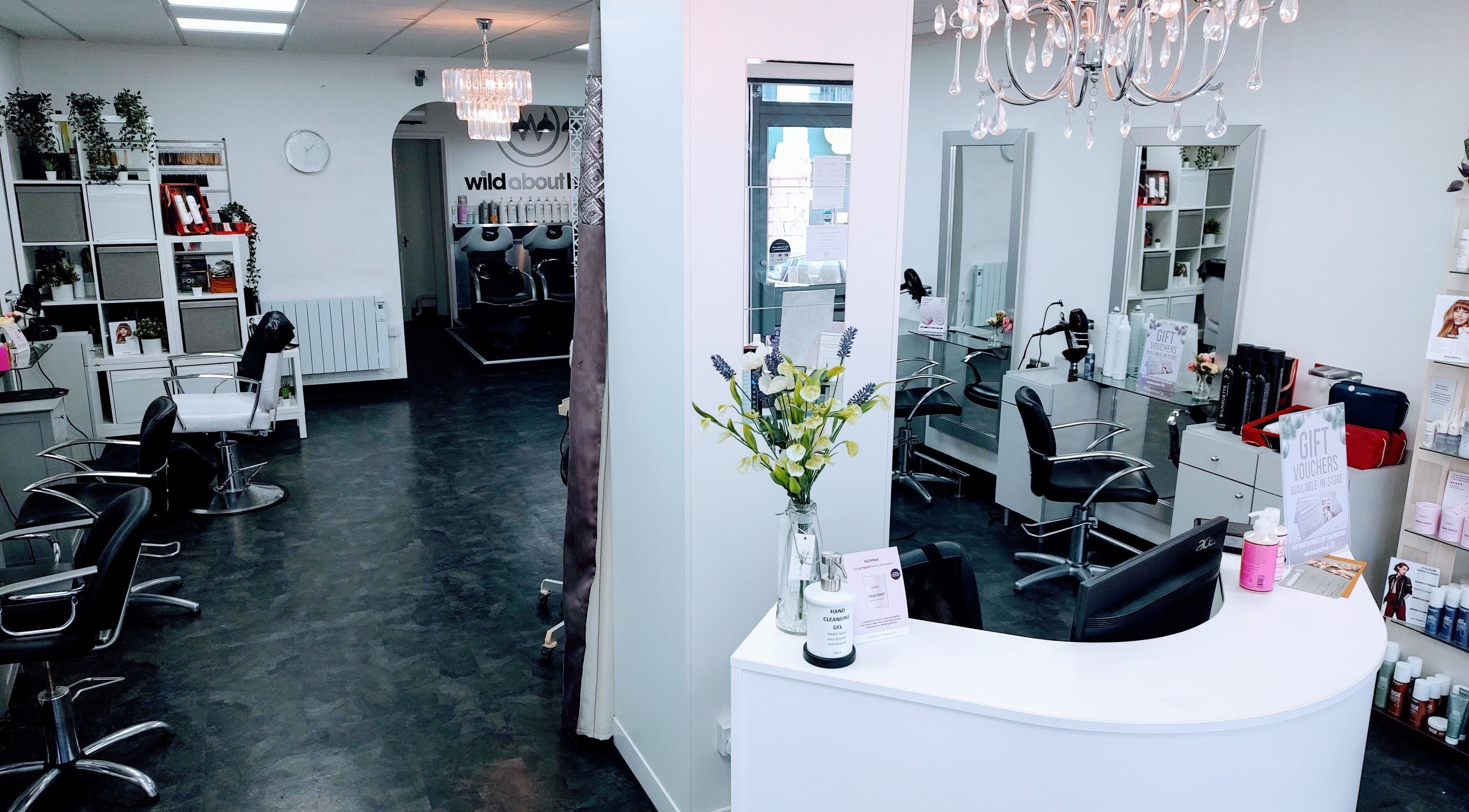 Chic interior of Wild About Hair, Torquay, England, GB. Stylish black chairs and modern decor create a welcoming ambiance.