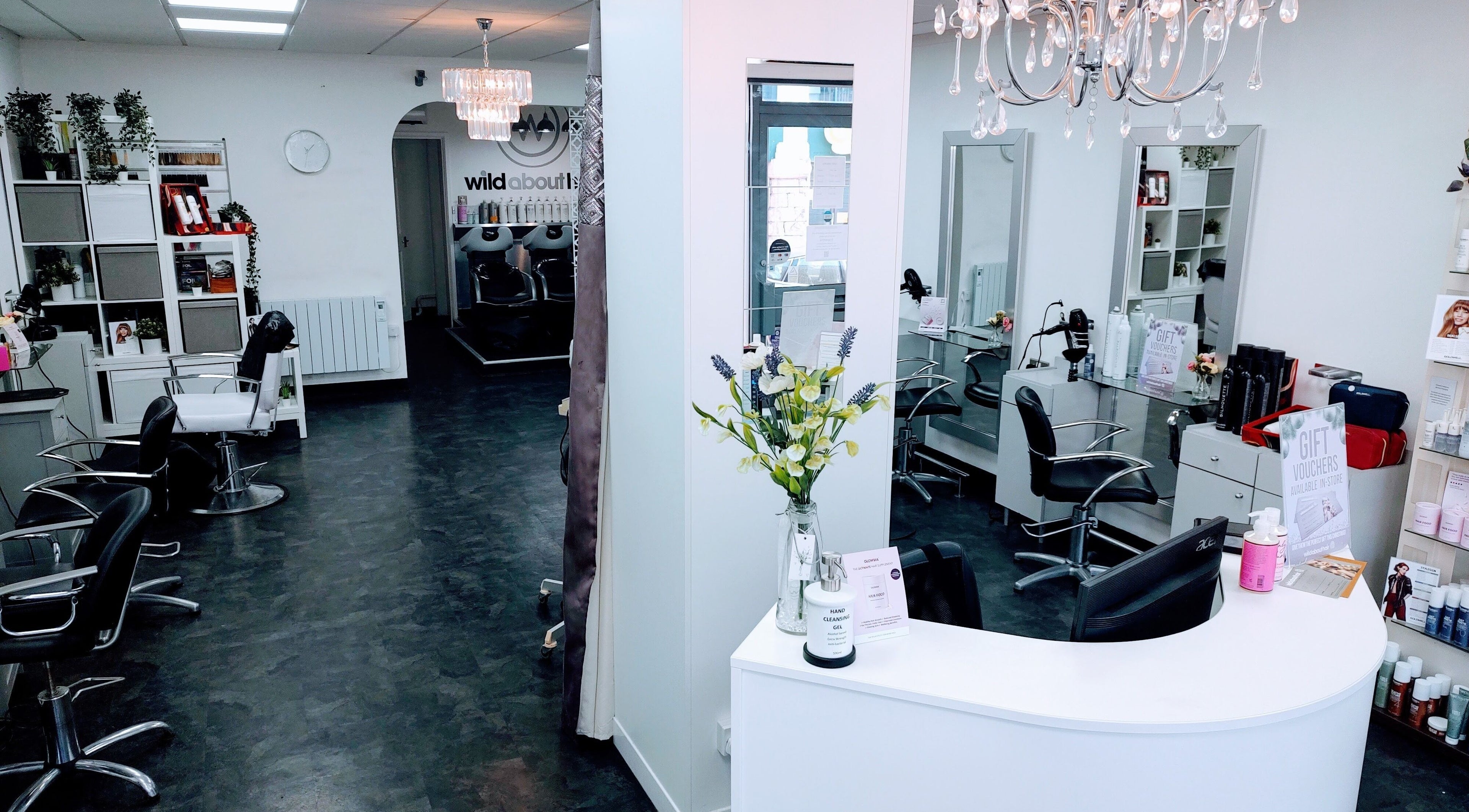 Chic interior of Wild About Hair, Torquay, England, GB. Stylish black chairs and modern decor create a welcoming ambiance.