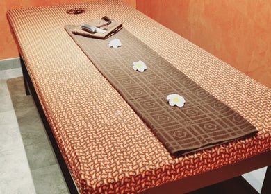 Elegant massage table setup at Sanje Wellness Gading Serpong in Banten, Banten, ID, featuring delicate floral accents.