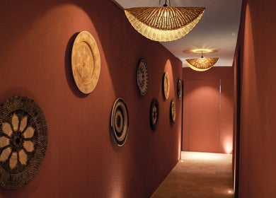 Elegant hallway at Sanje Wellness Gading Serpong, Banten, ID, featuring artistic wall decor and warm lighting.