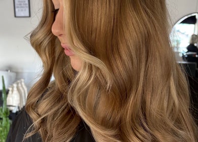 Elegant blonde waves styled at Hair by Liv, Stamford, England, GB. Luxurious salon experience captured.