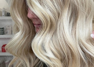 Blonde wavy hairstyle at Hair by Liv, Stamford, England, GB, showcasing expert styling.