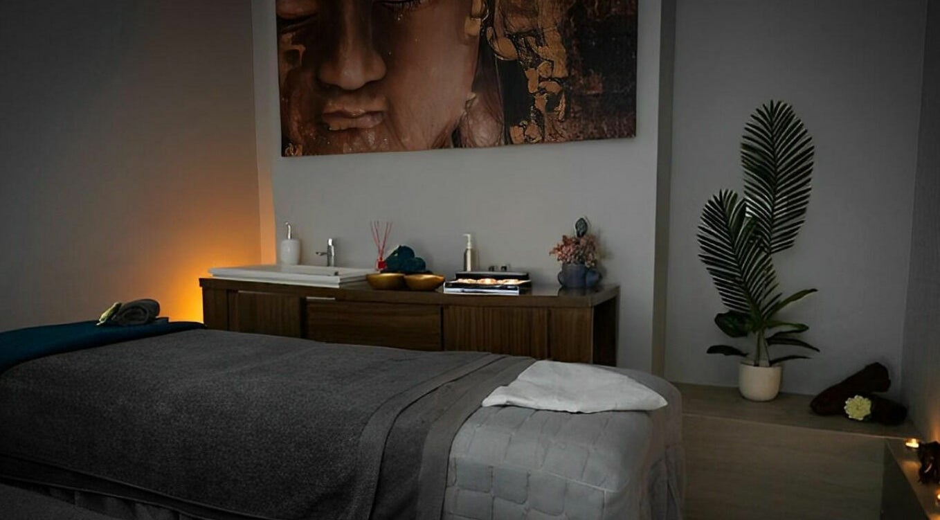 Relaxing massage room at Oasis Spa Therapy in WORTHING, England, GB, with ambient lighting and decor.