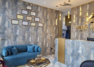 Stylish reception area at Jollie Atelier Beauty Center, Dubai, Dubai, AE with modern design and framed certificates.