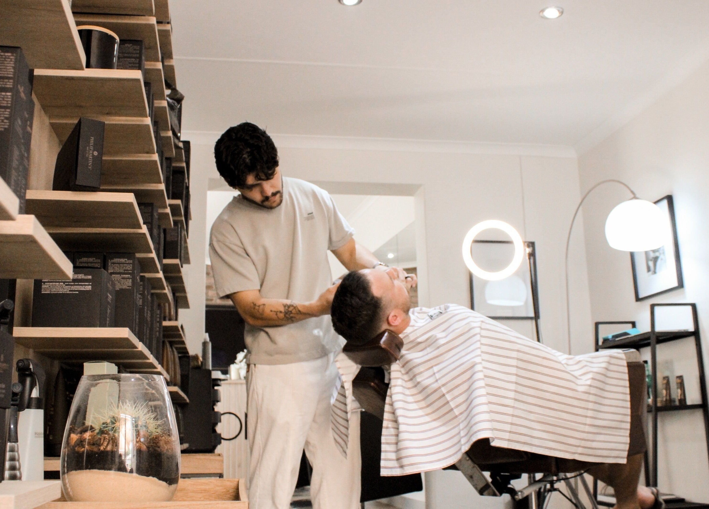 A barber provides a shave to a client at The Barber in Bloemfontein, Free State, ZA.
