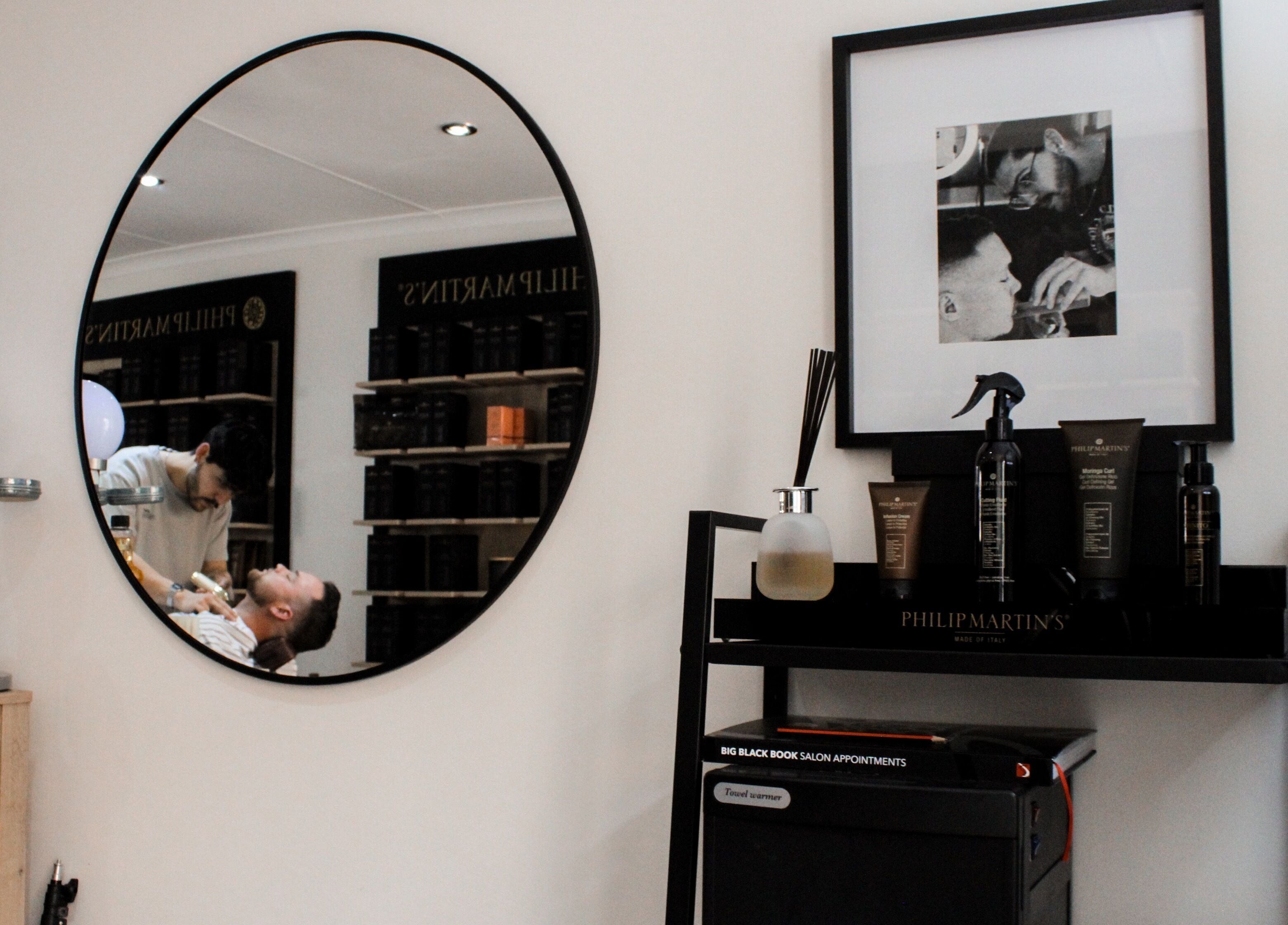 Stylish interior of The Barber with products and mirror reflection, Bloemfontein, Free State, ZA.