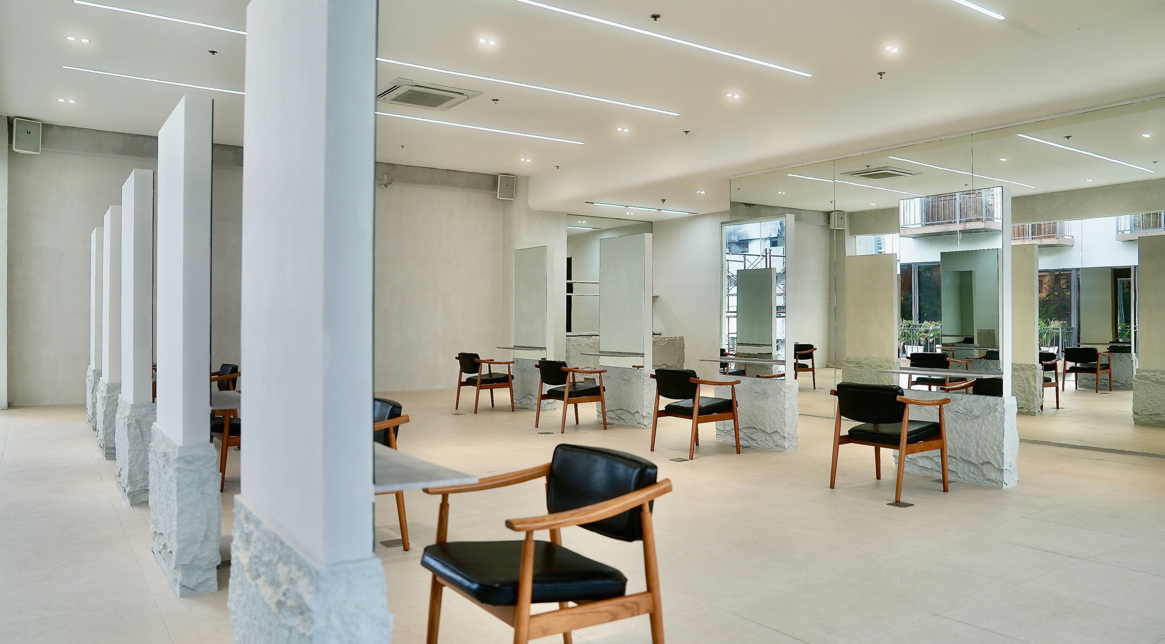 Spacious, modern interior of Rinoa Japanese Hair Salon in Cebu City, Central Visayas, PH with stylish chairs.