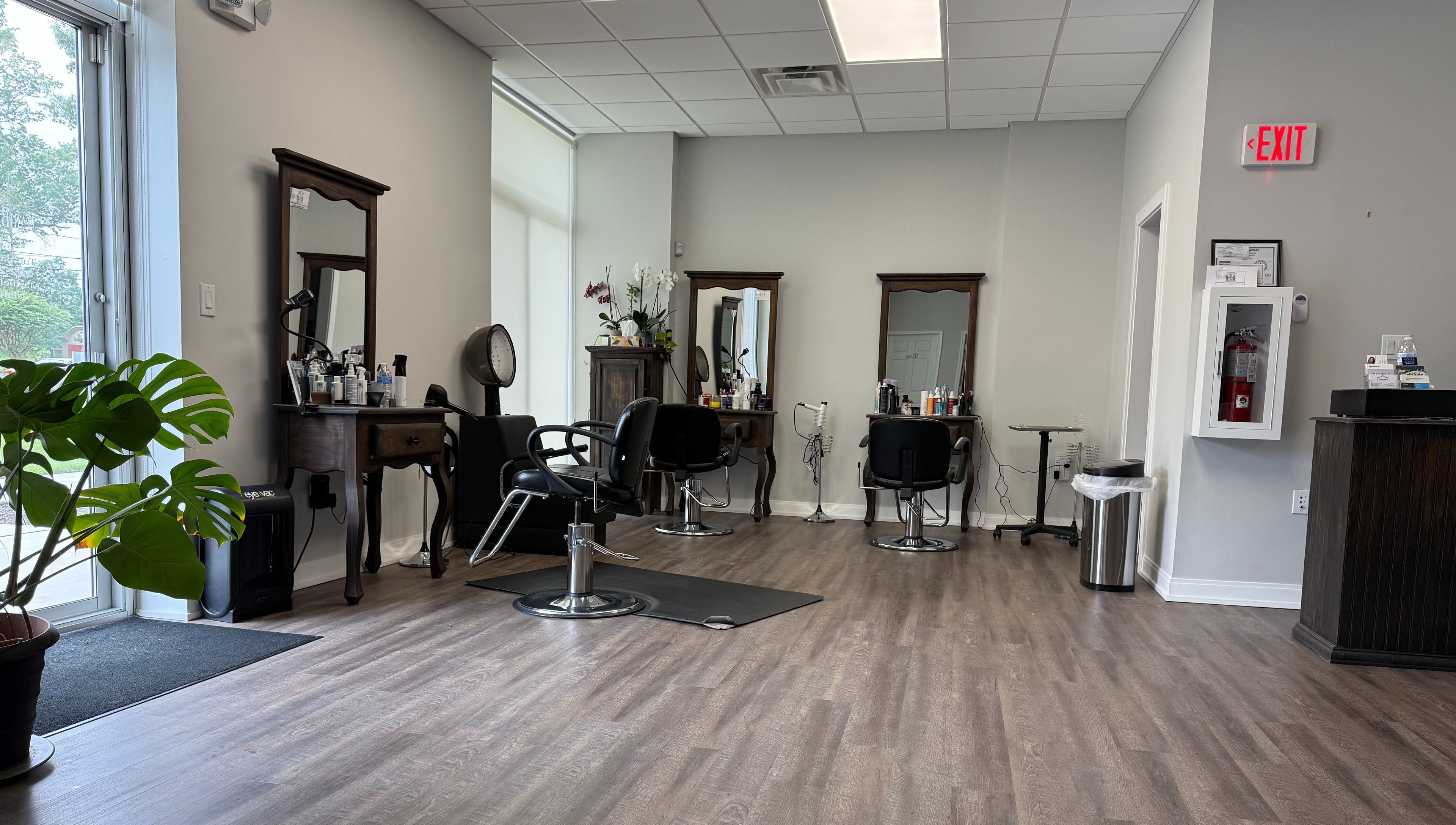 Interior of Maribella Salon LLC in Wilmington, Delaware, US showcasing sleek styling stations and greenery.
