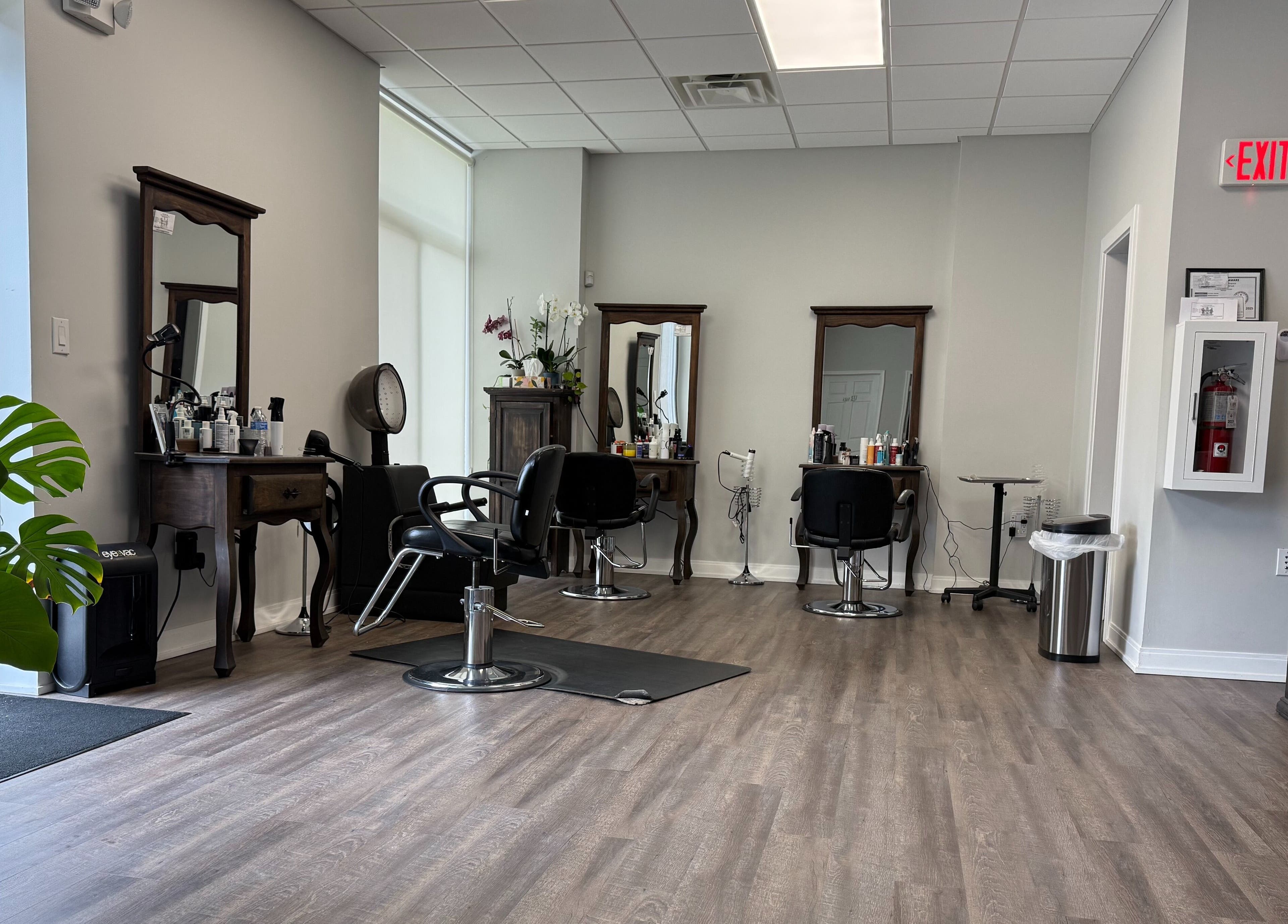 Interior of Maribella Salon LLC in Wilmington, Delaware, US showcasing sleek styling stations and greenery.