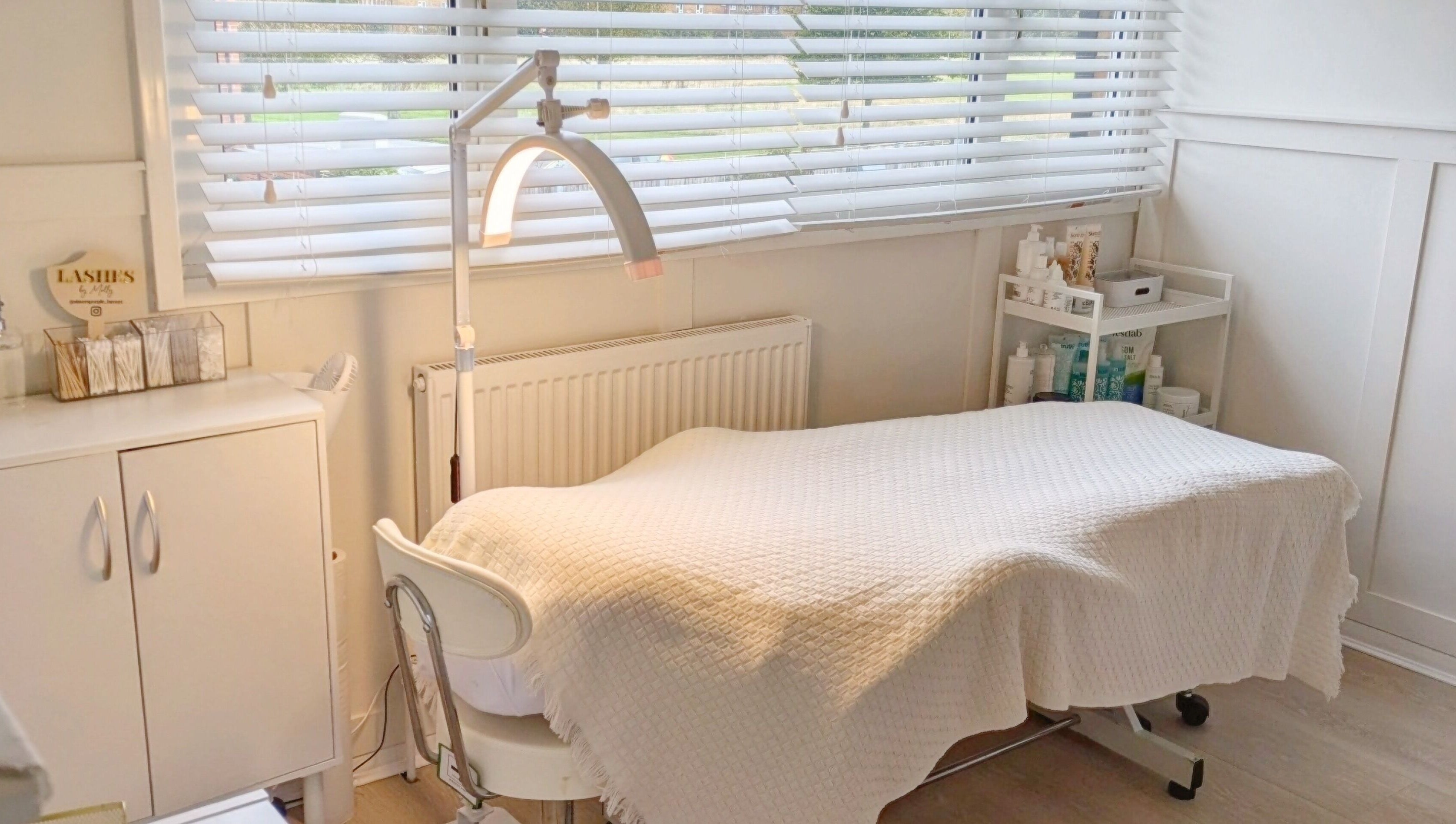 A serene treatment room at Bespoke Brows & Lashes in Havant, England, GB, featuring a cozy bed and soft lighting.