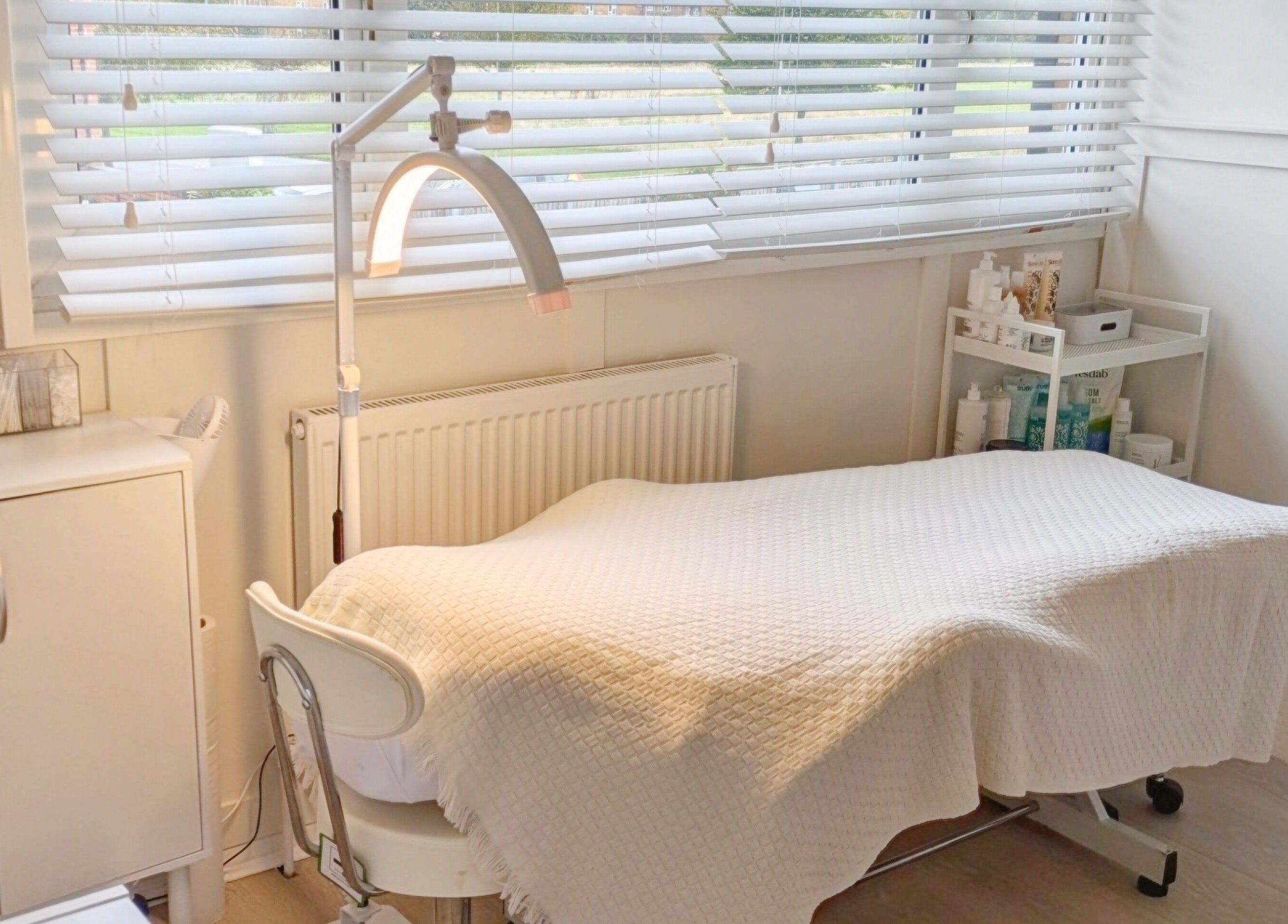 A serene treatment room at Bespoke Brows & Lashes in Havant, England, GB, featuring a cozy bed and soft lighting.