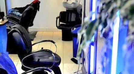 Modern interior of Daniel and Andrew Salon in Dublin, County Dublin, IE featuring stylish chairs and washing stations.