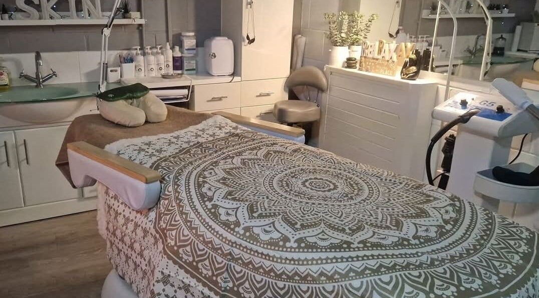 Cozy massage room at The White Lounge, Sunderland, England, GB, featuring a patterned blanket and soothing decor.