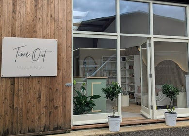 Elegant entrance of Time Out Beauty, Piercing & Aesthetics in Godalming, England, GB showcasing wooden facade.