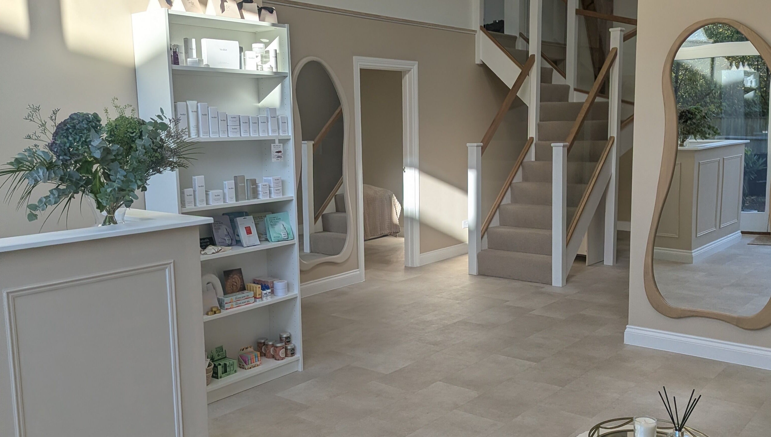 Elegant interior of Time Out Beauty, Piercing & Aesthetics in Godalming, England, GB with chic decor and product displays.