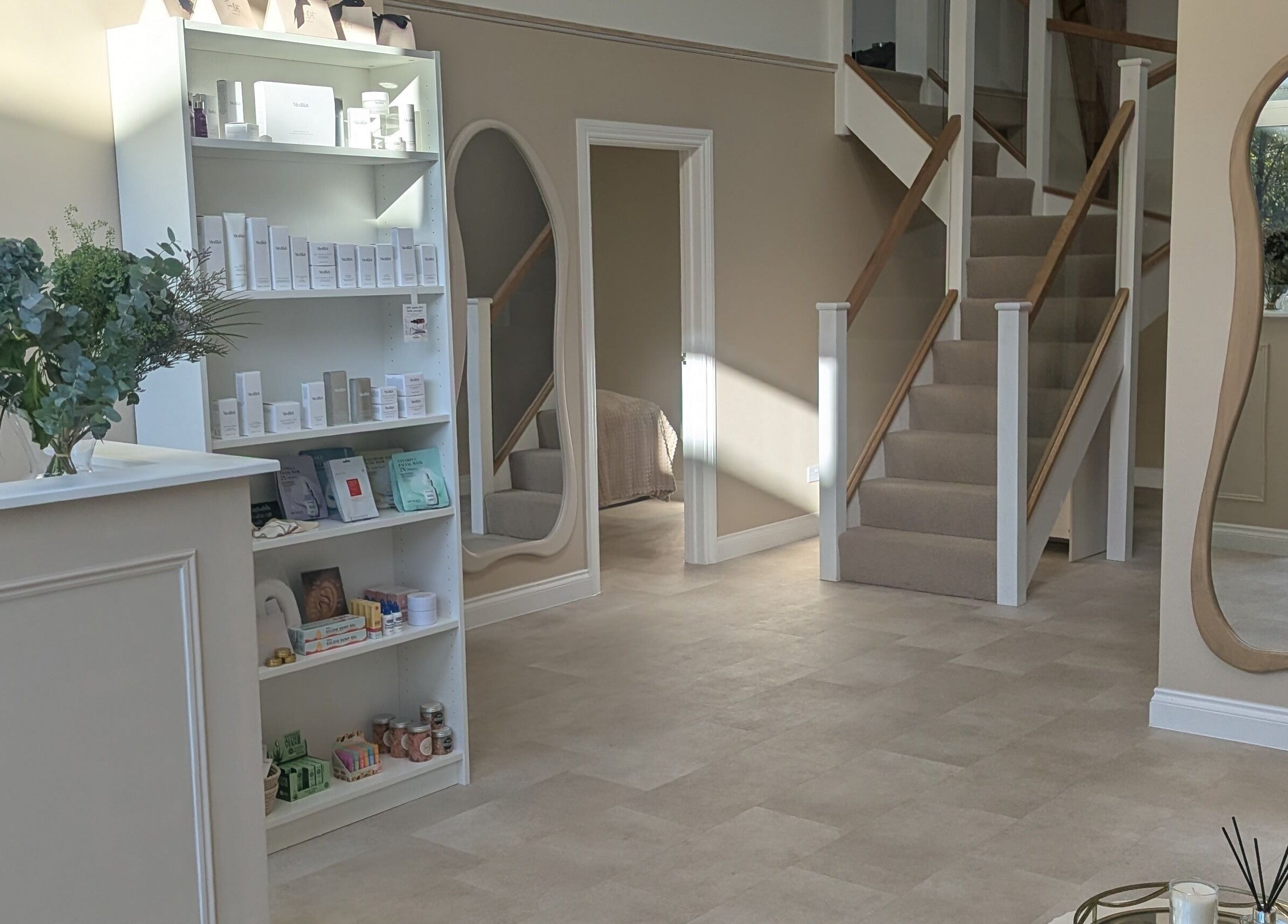 Elegant interior of Time Out Beauty, Piercing & Aesthetics in Godalming, England, GB with chic decor and product displays.