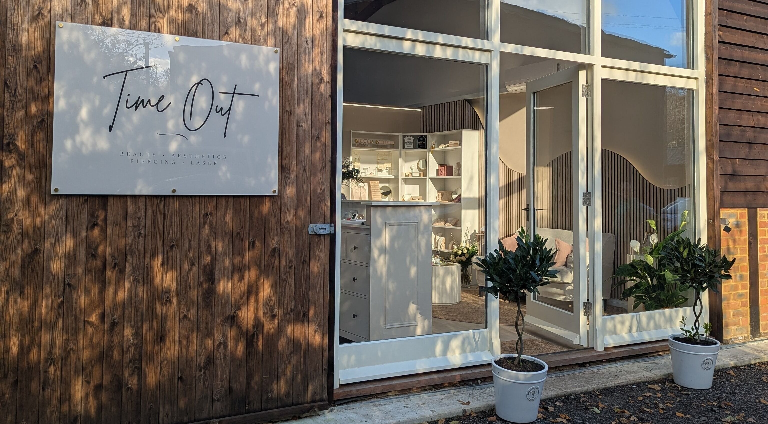 Elegant entrance of Time Out Beauty, Piercing & Aesthetics in Godalming, England, GB with welcoming decor.