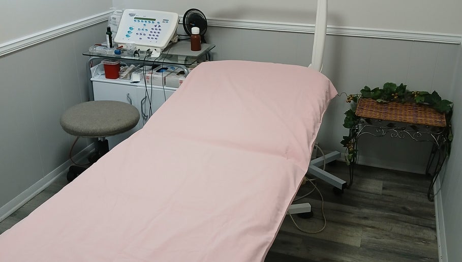 Cozy treatment room at Unicorn Electrolysis, Columbus, Ohio, US, featuring a pink-covered bed.