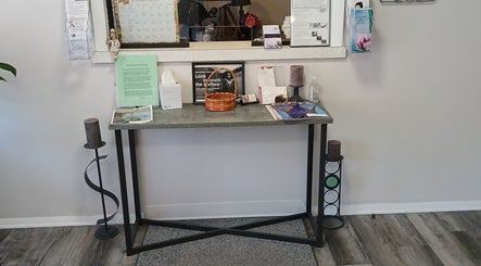 Chic entry setup at Unicorn Electrolysis in Columbus, Ohio, US, with table, brochures, and decor.
