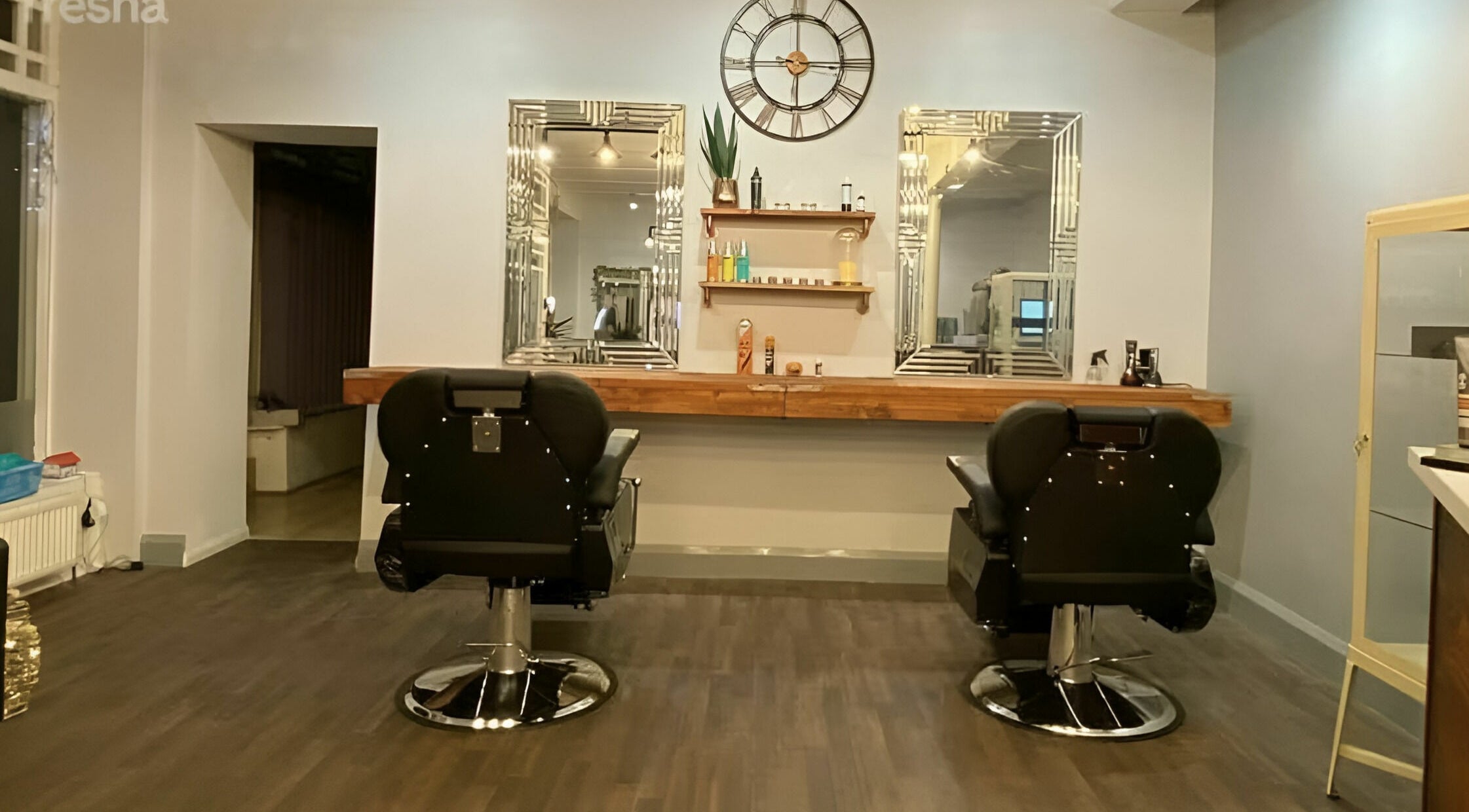 Elegant styling chairs and mirrors at Haigh&Co in Linthwaite, England, GB, showcasing chic salon design.