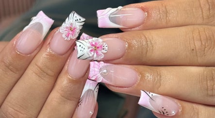 Exquisite nail art with pink and white floral designs at Brahmaloka, High Wycombe, England, GB.