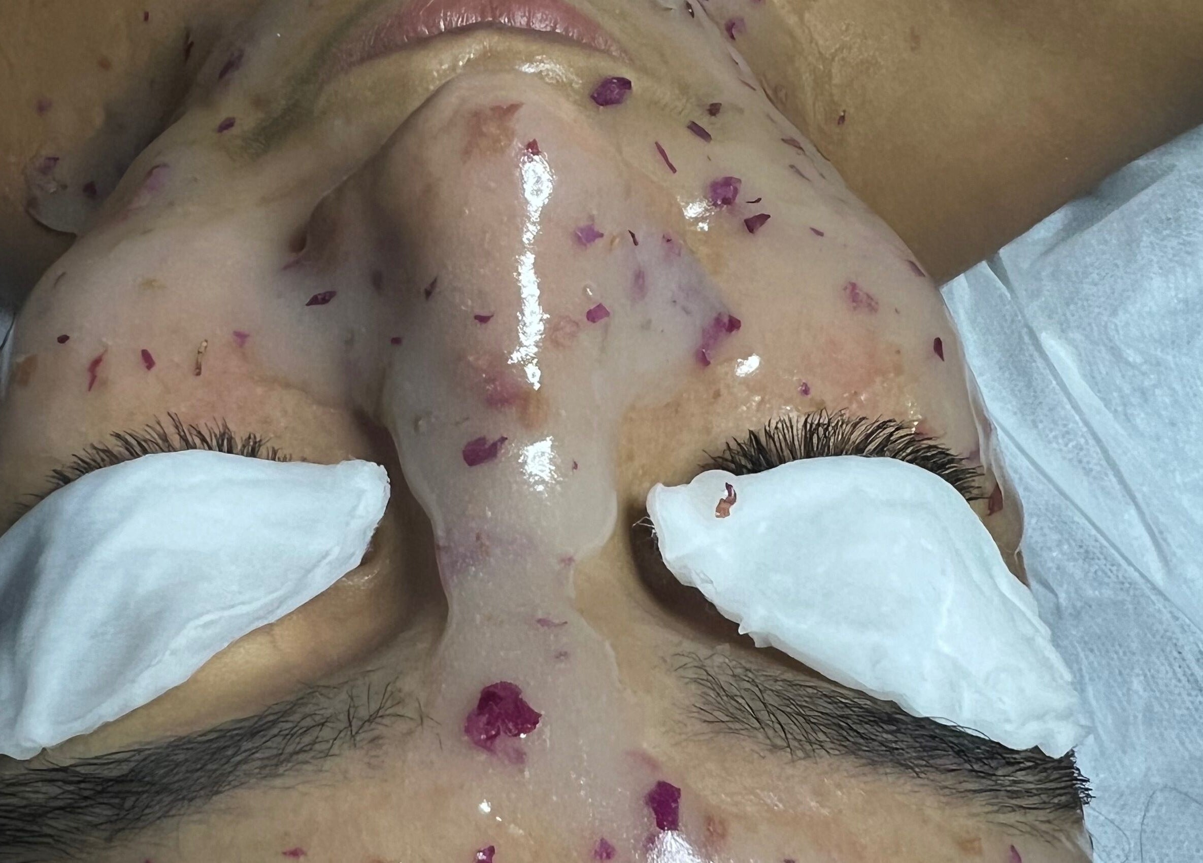 Revitalizing face mask at ABY SKIN CARE, New York, New York, US, with rose petal accents.