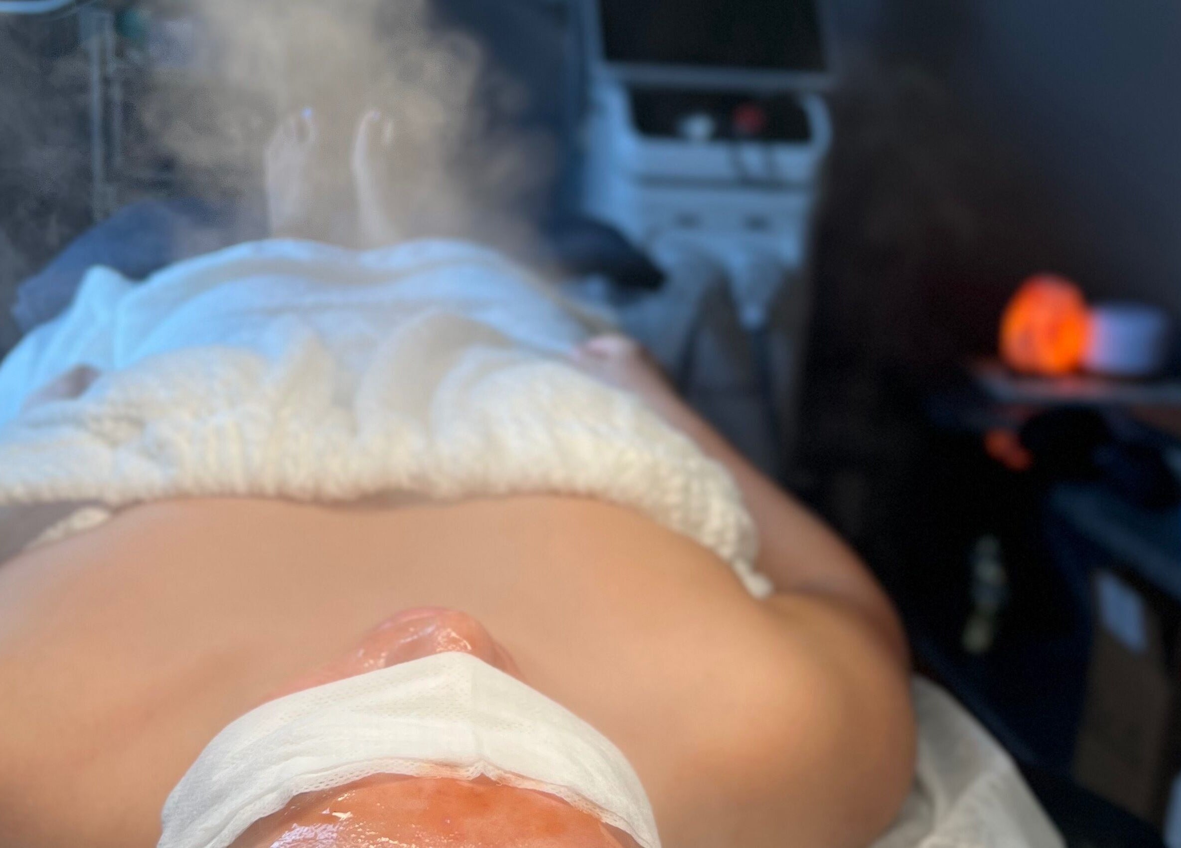 Facial treatment at ABY SKIN CARE, New York, New York, US, with steam and serene ambiance.