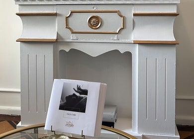 Elegant mantelpiece at Flávio Vilhais SkinLab, Lisboa, Lisboa, PT with a face care brochure displayed.