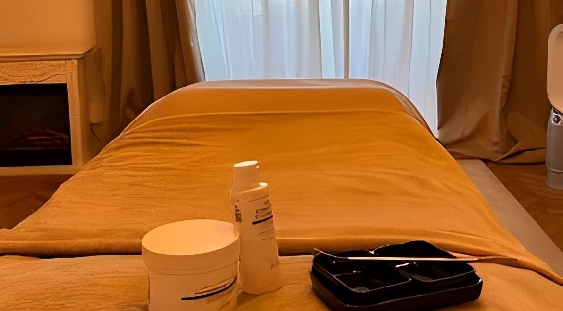 Luxurious treatment room at Flávio Vilhais SkinLab, Lisboa, Lisboa, PT, with essentials on a massage table.