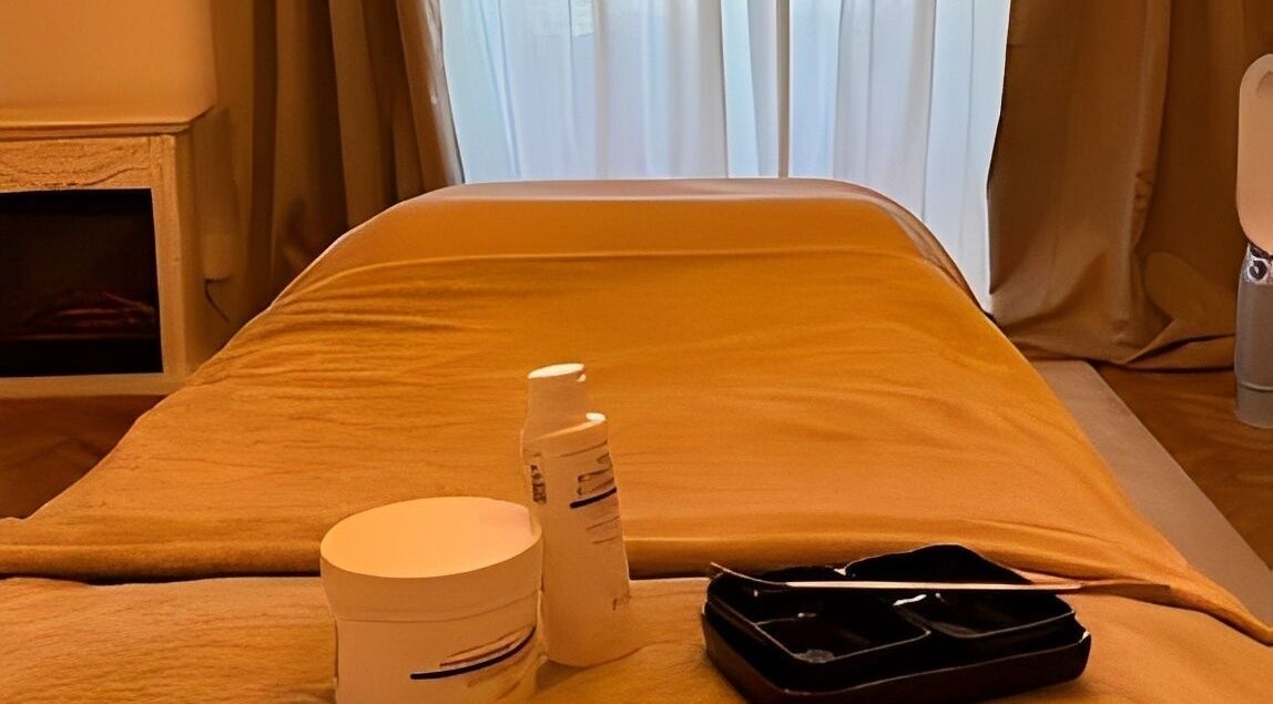 Luxurious treatment room at Flávio Vilhais SkinLab, Lisboa, Lisboa, PT, with essentials on a massage table.