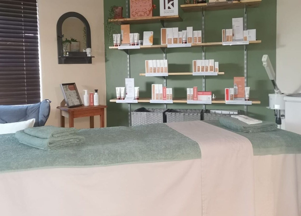 Relaxing spa room at Be You Holistic Wellness, Cape Town, Western Cape, ZA with treatment bed and product shelves.