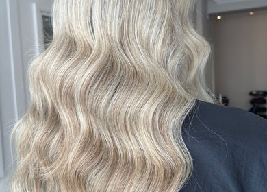 Elegant blonde waves styled at Joseph Rotchford Hair in Harrogate, England, GB, showcasing salon's expertise.