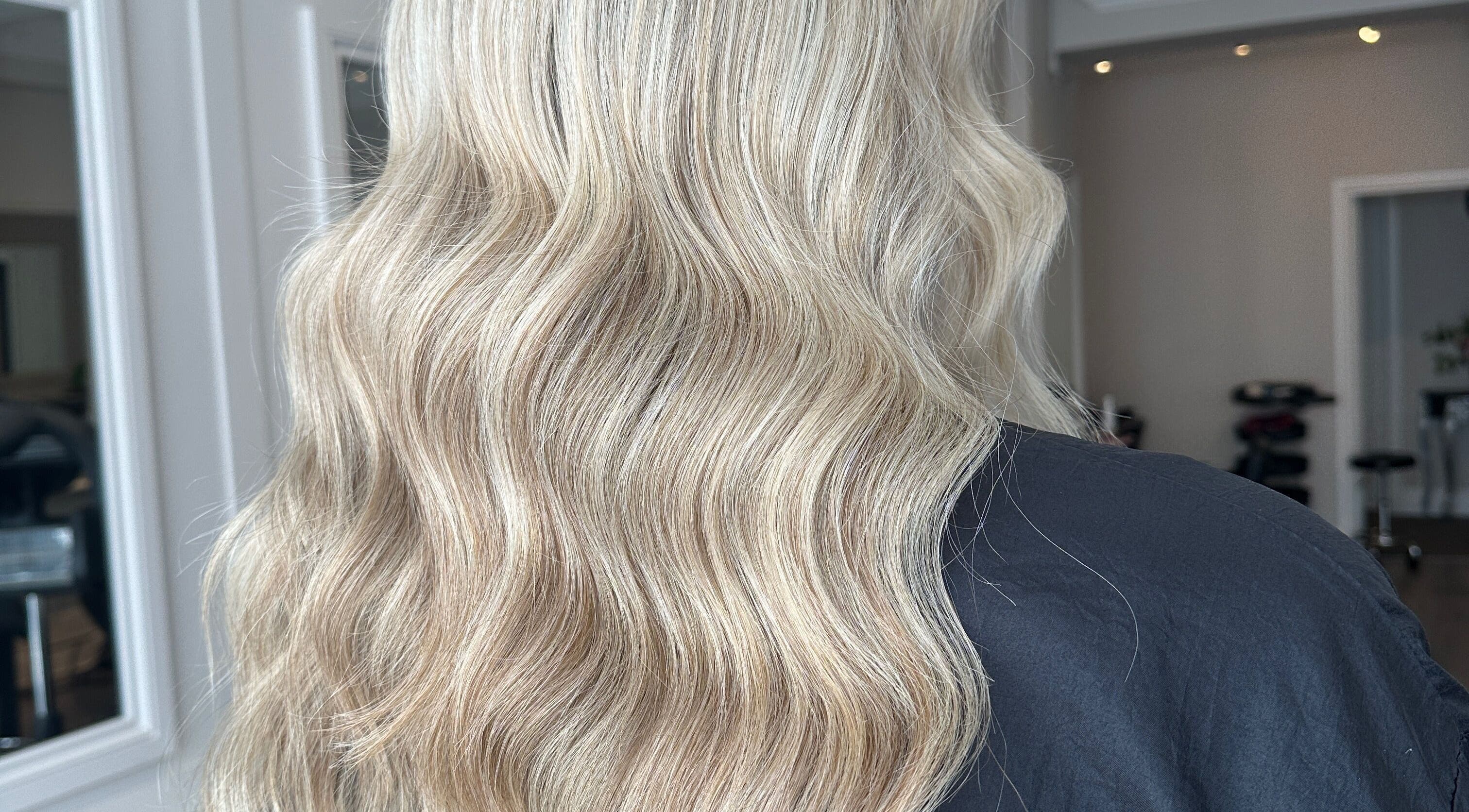 Elegant blonde waves styled at Joseph Rotchford Hair in Harrogate, England, GB, showcasing salon's expertise.